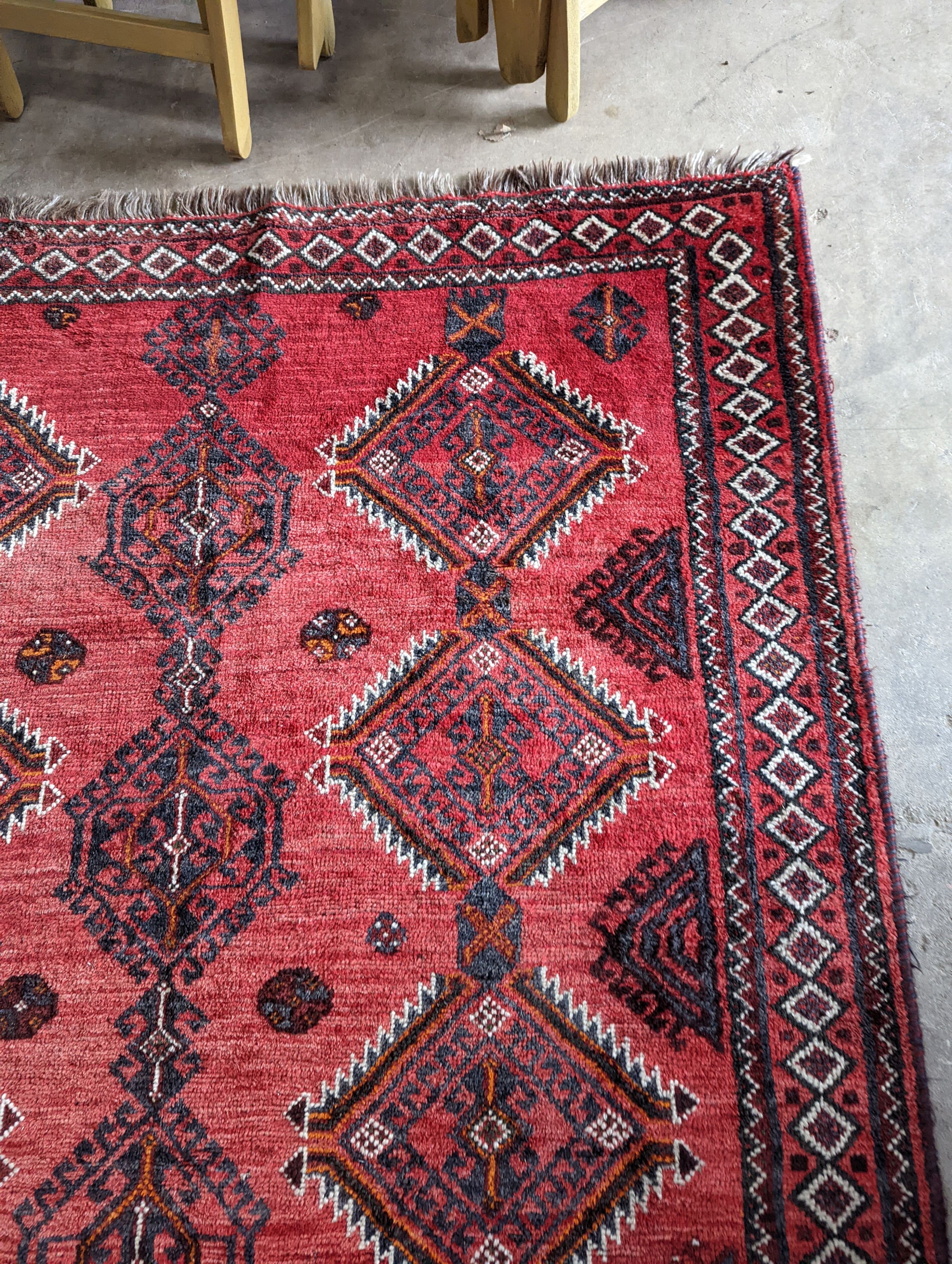 A Caucasian style red ground rug, 255 x 167cm